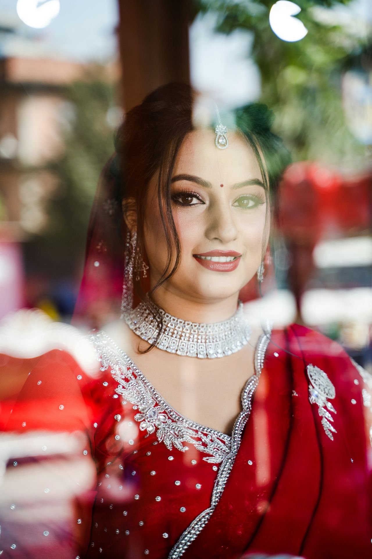 a woman in a red dress is looking out a window